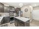 Kitchen featuring an island with quartz counters, modern stainless appliances, and neutral gray walls at 126 Winding Brook Way, Pendleton, IN 46064