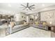 Spacious living room with gray couches, decorative rug, and a modern ceiling fan at 126 Winding Brook Way, Pendleton, IN 46064