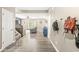 Inviting foyer with hardwood flooring that opens to a cozy living room with a ceiling fan and natural light at 126 Winding Brook Way, Pendleton, IN 46064