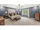 Spacious bedroom features a tray ceiling, ceiling fan, and an abundance of natural light from the large window at 126 Winding Brook Way, Pendleton, IN 46064