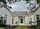 The home's backyard features white siding, sliding glass doors, well-maintained landscaping, and a patio at 12656 Cerromar Ct, Carmel, IN 46033
