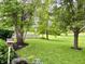 Backyard featuring mature trees, a well-maintained lawn and professional landscaping at 12656 Cerromar Ct, Carmel, IN 46033