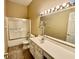 Bathroom with a shower-tub combo, updated vanity, and neutral tile, offering a clean and functional design at 12656 Cerromar Ct, Carmel, IN 46033
