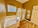Bathroom featuring a garden tub, walk-in shower, and decorative wall art creating a relaxing and stylish space at 12656 Cerromar Ct, Carmel, IN 46033