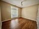 Bright bedroom with hardwood floors, a large window offering natural light, and neutral paint creating a serene space at 12656 Cerromar Ct, Carmel, IN 46033