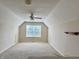 Finished bonus room with a ceiling fan, natural light, and neutral carpeting, perfect for flexible living space at 12656 Cerromar Ct, Carmel, IN 46033