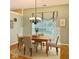 Inviting breakfast area featuring a window, chandelier, and seating for four on an area rug at 12656 Cerromar Ct, Carmel, IN 46033