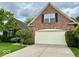 Charming brick home featuring a manicured lawn and an attached two-car garage at 12656 Cerromar Ct, Carmel, IN 46033