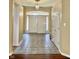 Open foyer with gray tile flooring and a view of the front door with sidelights at 12656 Cerromar Ct, Carmel, IN 46033