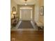 Inviting foyer with tile flooring, front door, and a console table creates a warm welcome at 12656 Cerromar Ct, Carmel, IN 46033