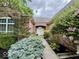 Close-up of the brick home's entrance, showing trimmed bushes and an attractive walkway to the front door at 12656 Cerromar Ct, Carmel, IN 46033