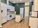 Bright kitchen with white cabinets, granite countertops, island, and stainless steel refrigerator at 12656 Cerromar Ct, Carmel, IN 46033