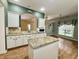 Open kitchen featuring granite countertops, island, and white cabinetry with stainless steel appliances at 12656 Cerromar Ct, Carmel, IN 46033