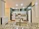 Modern kitchen with granite countertops, island with sink, and white appliances at 12656 Cerromar Ct, Carmel, IN 46033