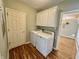 Functional laundry room equipped with a washer and dryer, and cabinetry for storage, providing convenience and organization at 12656 Cerromar Ct, Carmel, IN 46033