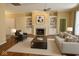 Bright living room with hardwood floors, fireplace, built-in shelving, and comfortable seating at 12656 Cerromar Ct, Carmel, IN 46033