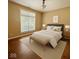 Well-lit main bedroom featuring a large window, hardwood floors, and a neutral color scheme for a relaxing ambiance at 12656 Cerromar Ct, Carmel, IN 46033