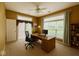 Bright home office featuring dual windows, ceiling fan, and built-in shelving at 12656 Cerromar Ct, Carmel, IN 46033