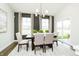 Bright dining room with modern chandelier, dark accent wall, and sliding glass door at 138 Rock Island Rd, Westfield, IN 46069