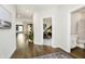 Hallway with wood flooring, leading to various rooms including a full bathroom at 138 Rock Island Rd, Westfield, IN 46069