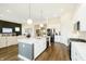 Open kitchen with white cabinets, stainless steel appliances, and granite countertops at 138 Rock Island Rd, Westfield, IN 46069