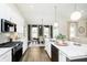 Stylish kitchen flowing into the dining area, featuring stainless appliances and granite countertops at 138 Rock Island Rd, Westfield, IN 46069