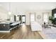Open-concept living space with hardwood floors, large windows, and modern decor at 138 Rock Island Rd, Westfield, IN 46069