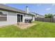 Spacious backyard features a stone patio with barbecue grills and a privacy fence at 1547 Millridge Dr, Greenwood, IN 46143