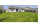 A home with a large green backyard and stone patio area ready for entertaining at 1547 Millridge Dr, Greenwood, IN 46143
