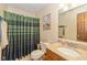 Bathroom featuring striped shower curtain, granite countertop, and ample vanity space at 1547 Millridge Dr, Greenwood, IN 46143