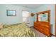 Bedroom featuring light green walls, natural light, and a wooden dresser at 1547 Millridge Dr, Greenwood, IN 46143