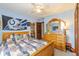Bedroom with blue walls, floral bedspread, and an Indianapolis Colts banner at 1547 Millridge Dr, Greenwood, IN 46143