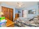 Bedroom with a floral bedspread, ceiling fan, and natural light at 1547 Millridge Dr, Greenwood, IN 46143