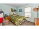 Bedroom with green walls, green comforter and natural light at 1547 Millridge Dr, Greenwood, IN 46143