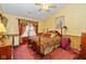 Comfortable bedroom featuring a poster bed, warm lighting, and decorative accents at 1547 Millridge Dr, Greenwood, IN 46143