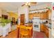 Eat-in kitchen featuring wooden cabinets, black countertops, appliances, and a cozy breakfast nook at 1547 Millridge Dr, Greenwood, IN 46143
