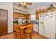 Eat-in kitchen with classic cabinets, black countertops, appliances, and a cozy breakfast nook at 1547 Millridge Dr, Greenwood, IN 46143