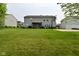 A lush backyard with a well-maintained lawn, a basketball court, and a cozy gazebo at 1744 Salina Dr, Avon, IN 46123