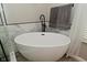 Freestanding tub with black fixtures and neutral colored tiles for a luxurious spa at 1744 Salina Dr, Avon, IN 46123