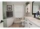 Bright bathroom featuring a tub, walk-in shower, and modern white double vanity at 1744 Salina Dr, Avon, IN 46123