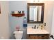 Powder room features decorative mirror and fixtures at 1744 Salina Dr, Avon, IN 46123