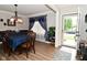 Formal dining room with elegant chandelier, hardwood floors, and stylish curtains at 1744 Salina Dr, Avon, IN 46123
