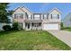 Charming two-story home with brick facade, well-manicured lawn, and inviting front porch at 1744 Salina Dr, Avon, IN 46123