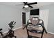 Compact carpeted home gym with ceiling fan features multiple exercise machines at 1744 Salina Dr, Avon, IN 46123