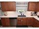 Kitchen features stainless appliances, light countertops, wood cabinets, and under cabinet lighting at 1744 Salina Dr, Avon, IN 46123
