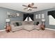 Comfortable living room has a large sectional sofa, carpet, and a ceiling fan at 1744 Salina Dr, Avon, IN 46123