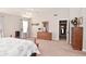 Open main bedroom featuring neutral carpeting, a ceiling fan, and a dresser with a mirror at 1744 Salina Dr, Avon, IN 46123