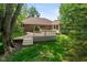 Spacious backyard features a wooden deck attached to a brick house, perfect for outdoor living at 180 Hollowview Dr, Noblesville, IN 46060