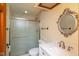 Well-lit bathroom features a shower with glass door, elegant mirror, and modern sink at 180 Hollowview Dr, Noblesville, IN 46060