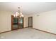 Dining room with light tile floors, chandelier and sliding glass doors at 180 Hollowview Dr, Noblesville, IN 46060